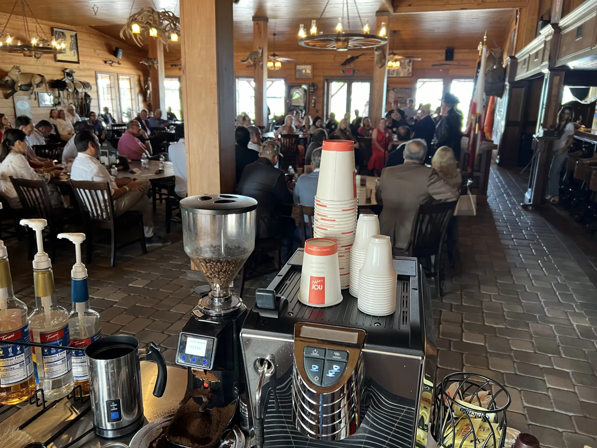 Professional coffee catering setup serving attendees at a corporate meet and greet event.